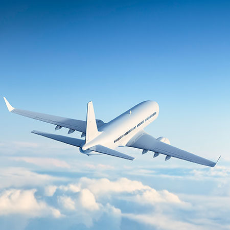 aircraft flying over clouds