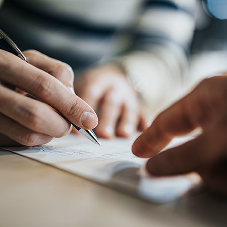 someone signing a document